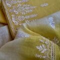 Traditional and Modern Embroidered Salwar Kameez on the floor with plant pot