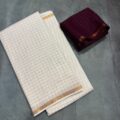 White Onam Saree with contrast blouse featuring copper zari border and zari checks by Aamir Fashion Textile.