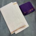 White Onam Saree with contrast blouse featuring copper zari border and zari checks by Aamir Fashion Textile.