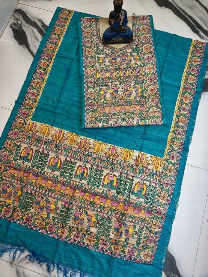 Tussar Ghicha Silk Madhubani Painting Dress Material on the floor with Budhdha Toy