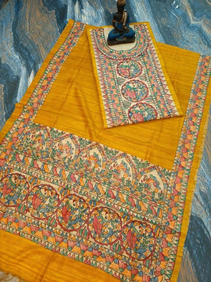 Tussar Ghicha Silk Madhubani Painting Dress Material on the floor with Budhdha Toy