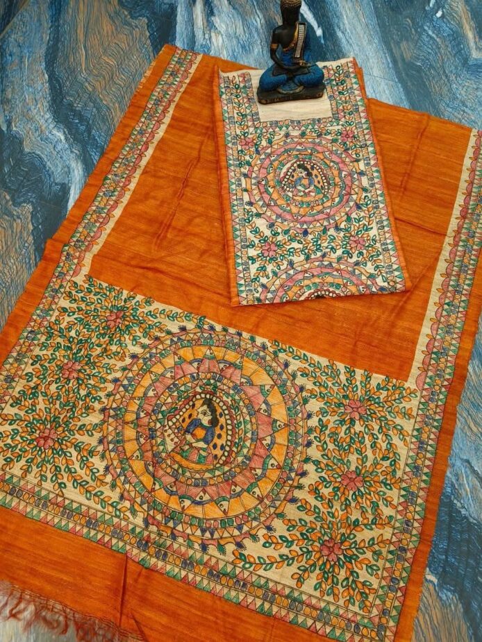 Tussar Ghicha Silk Madhubani Painting Dress Material on the floor with Budhdha Toy