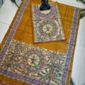 Tussar Ghicha Silk Madhubani Painting Dress Material on the floor with Budhdha Toy