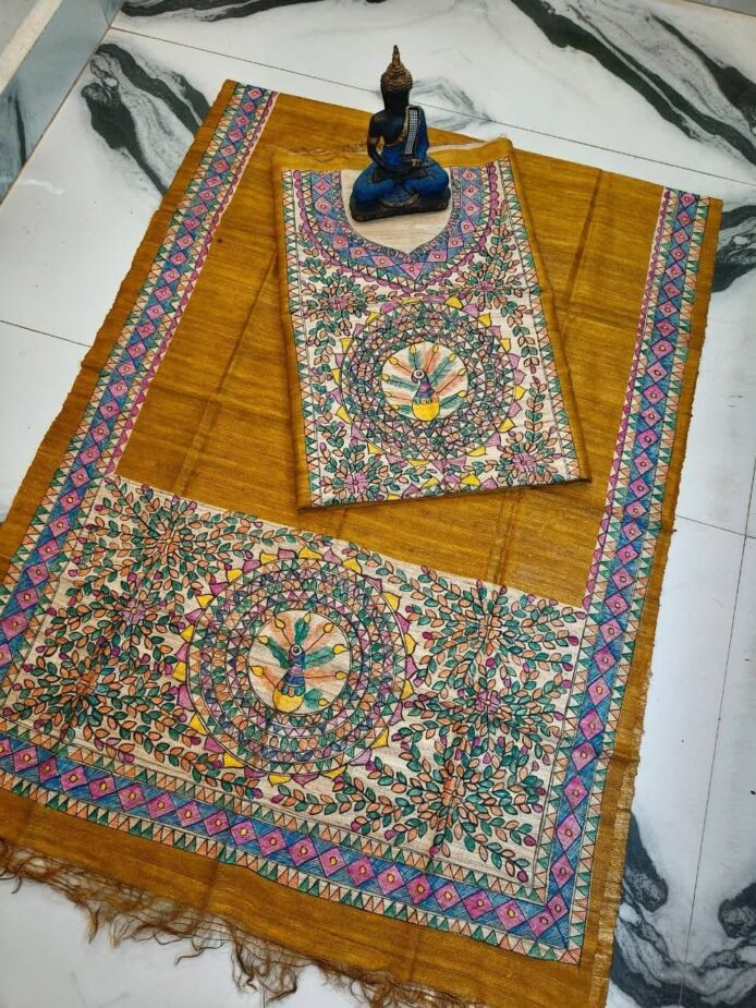 Tussar Ghicha Silk Madhubani Painting Dress Material on the floor with Budhdha Toy